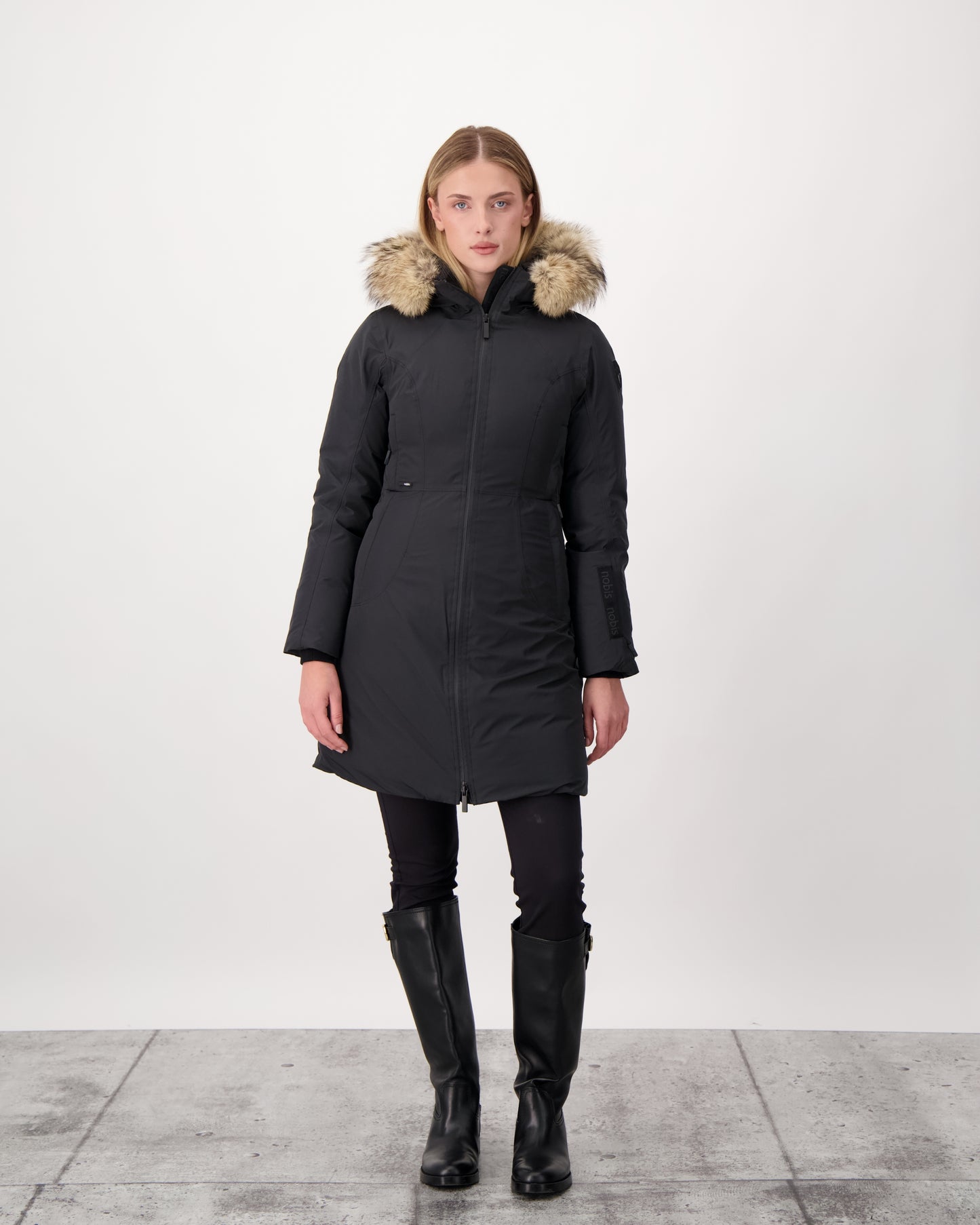 Ladies thigh length down-filled parka with non-removable hood and removable coyote fur trim in Black