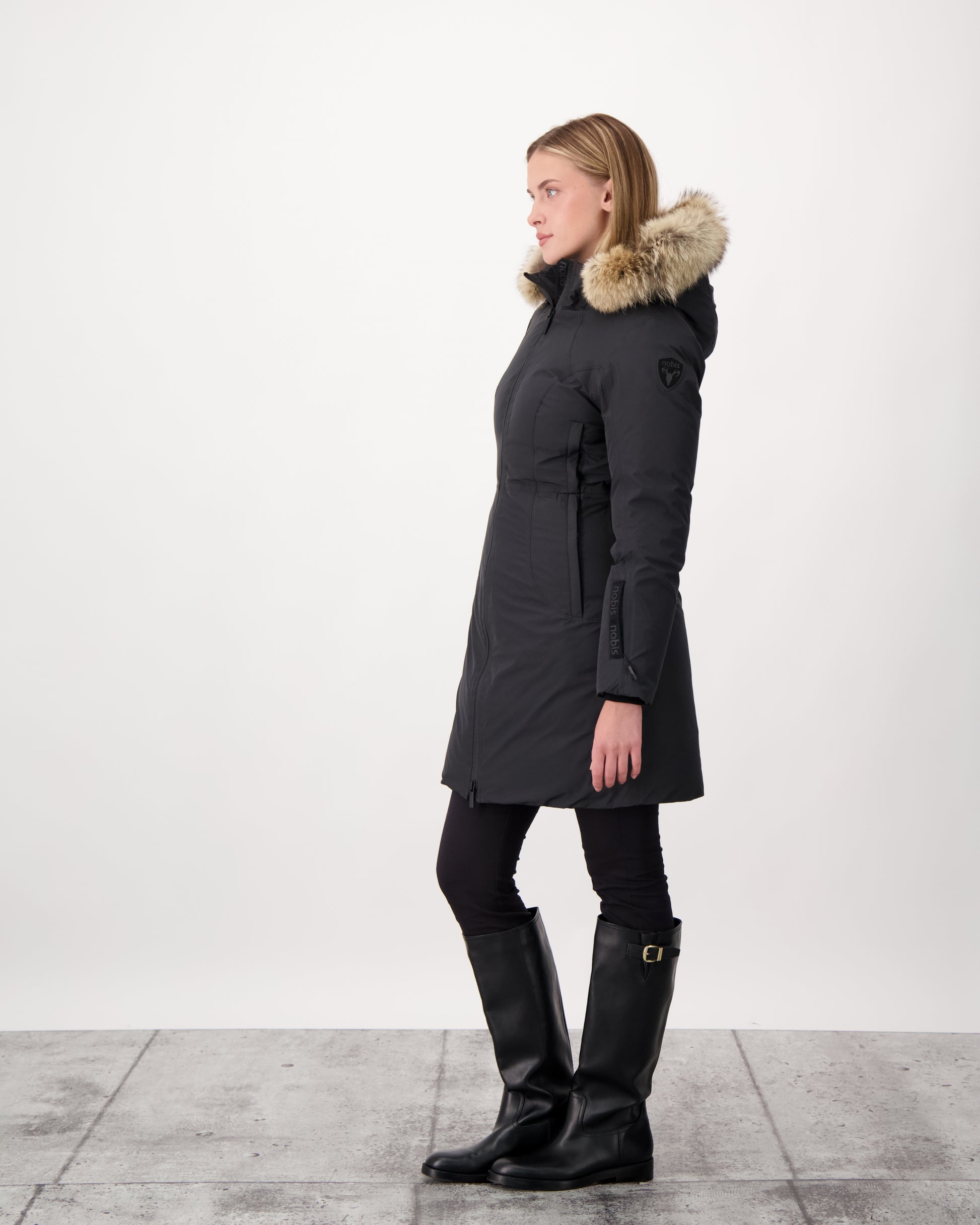 Ladies thigh length down-filled parka with non-removable hood and removable coyote fur trim in Black