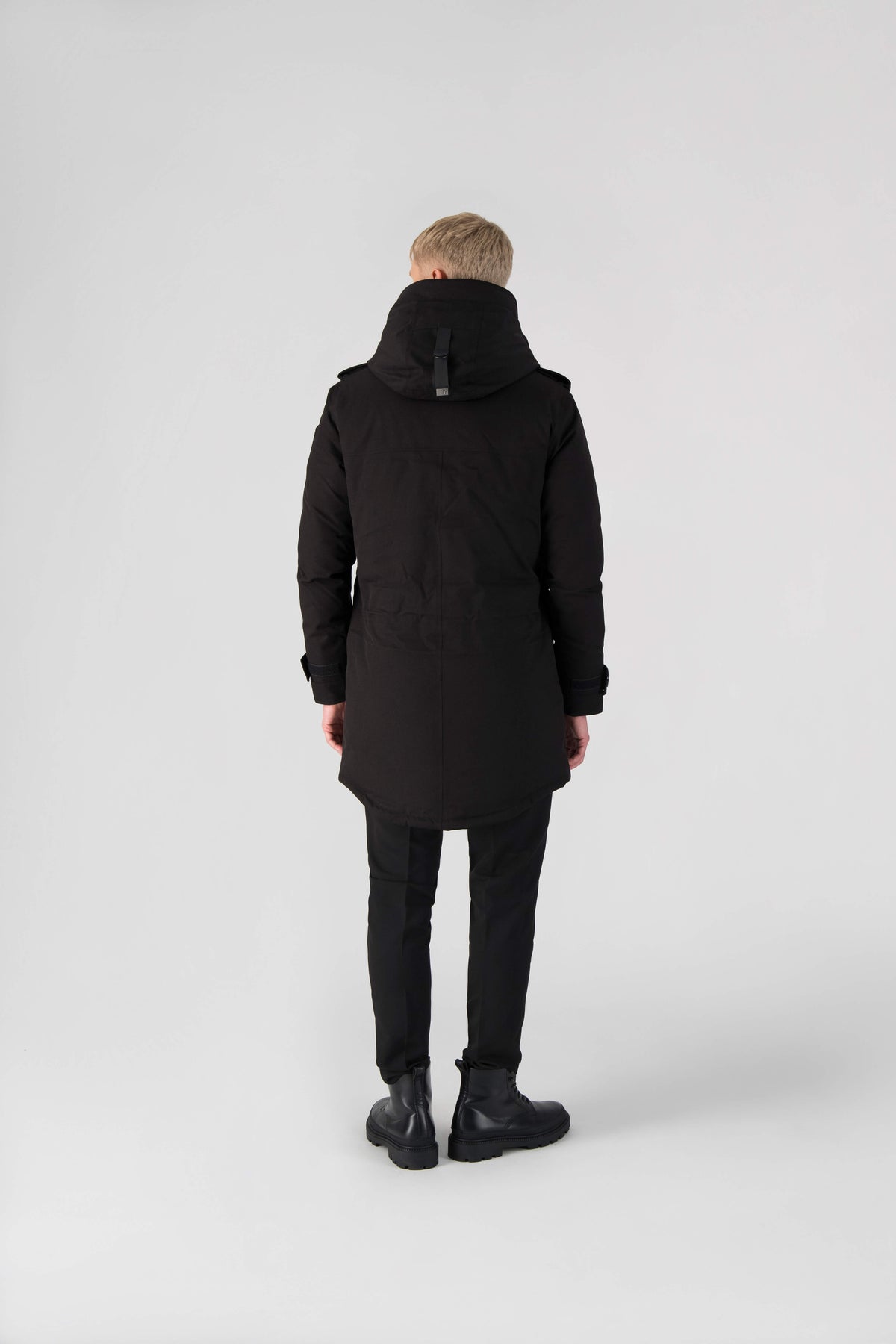 Men's down filled parka with faux button magnet closures and fur free hood with a fishtail hemline in Black