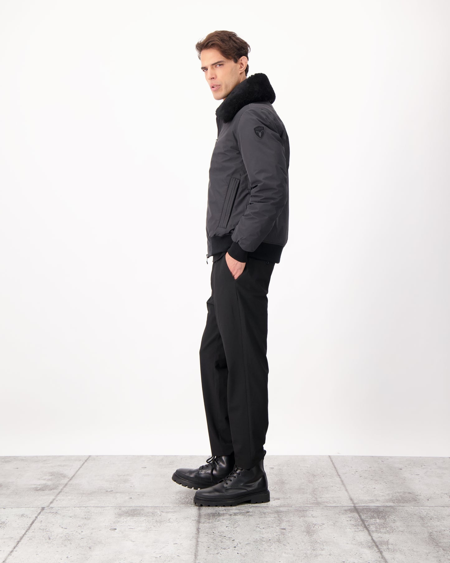 Sonar Men's Aviator Jacket in hip length, Canadian duck down insulation, removable shearling collar with hidden tuckable hood, and two-way front zipper, in Black
