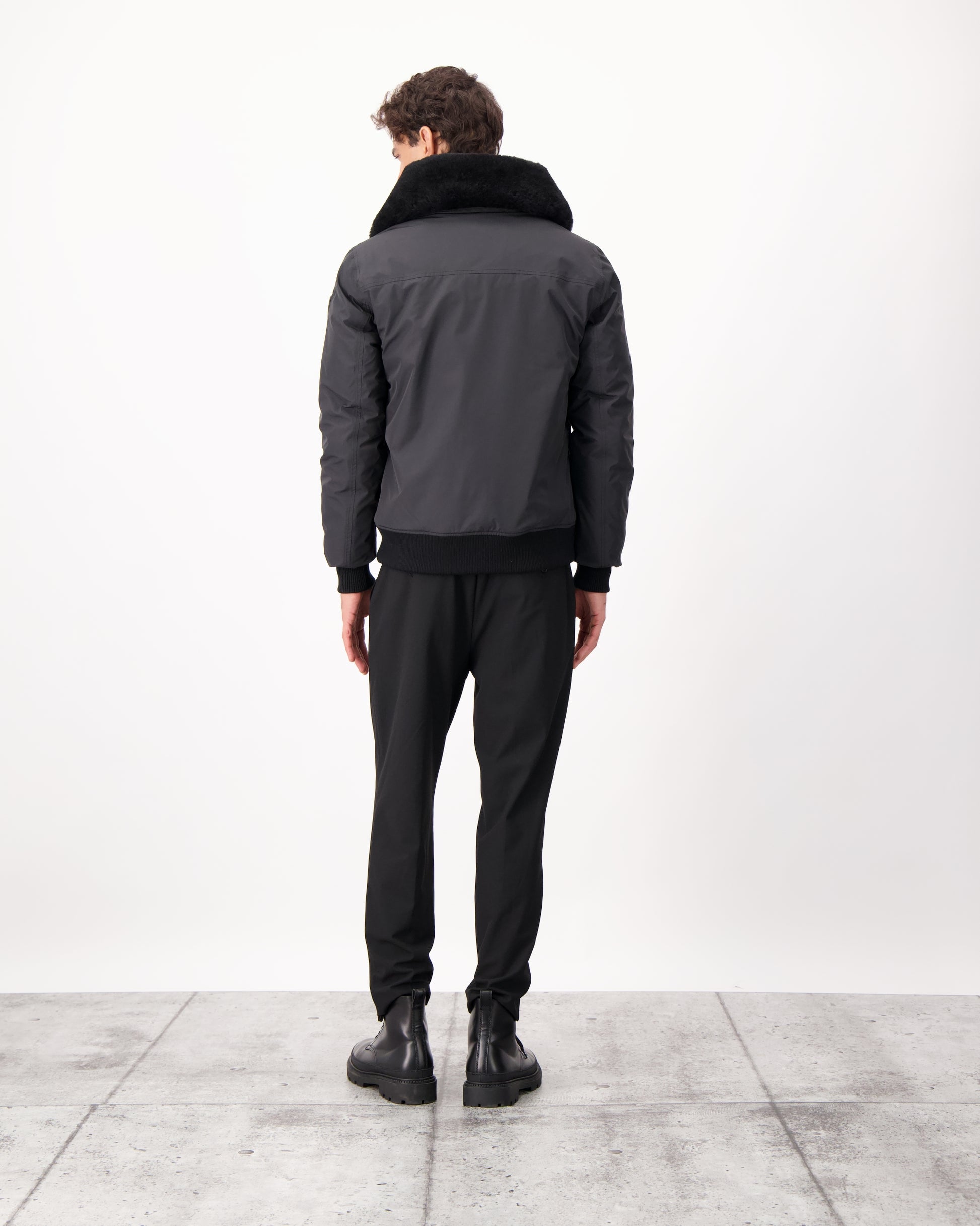 Sonar Men's Aviator Jacket in hip length, Canadian duck down insulation, removable shearling collar with hidden tuckable hood, and two-way front zipper, in Black