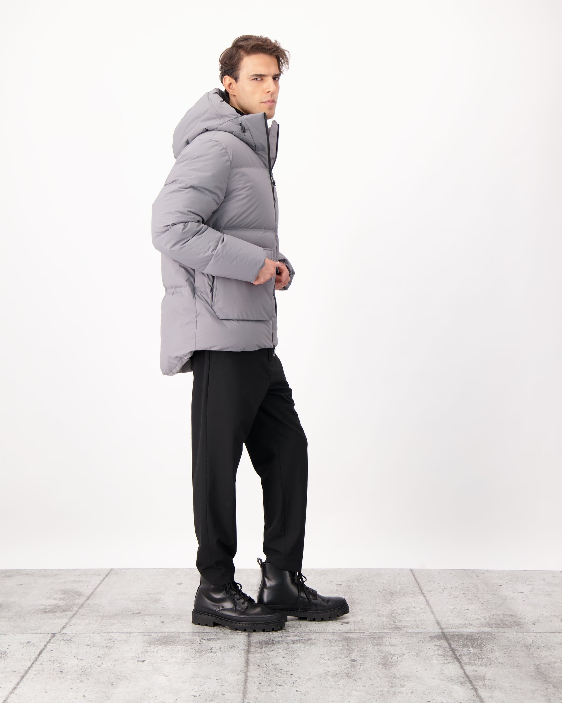 Supra Men's Performance Puffer in hip length, Technical Taffeta and 3-Ply Micro Denier fabrication, Premium Canadian White Duck Down insulation, non-removable down filled hood, centre front two-way zipper, flap pockets at waist, and zipper pocket at left bicep, in Concrete