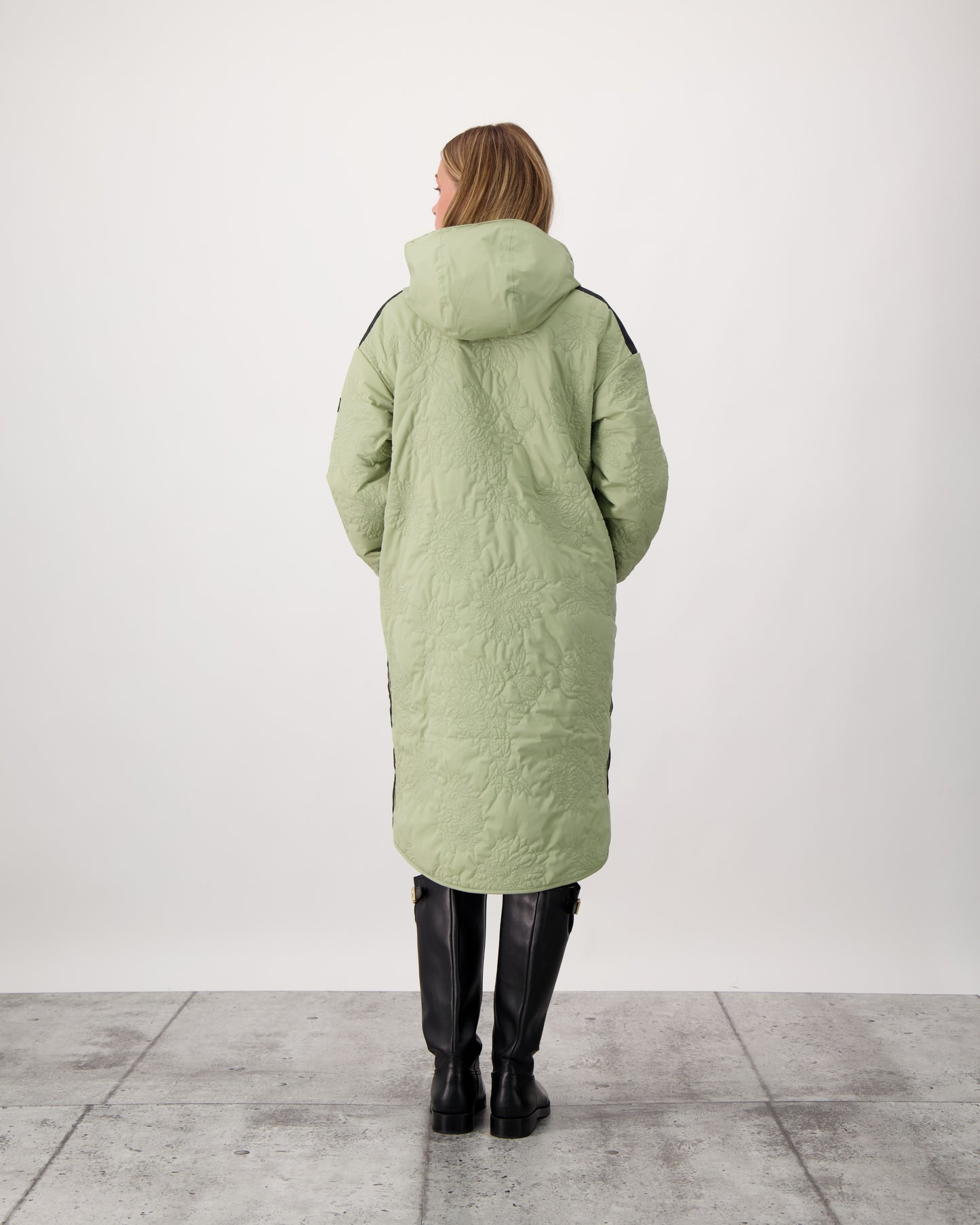 Surrey Women's Performance Quilted Long Mid Layer Jacket in knee length, Primaloft Gold Insulation Active+, non-removable hood, single welt magnetic closure pockets, ribbed cuffs, two-way centre front zipper, grosgrain ribbon detail and shoulders and side seam, and snap closure side seam vents, in Tea