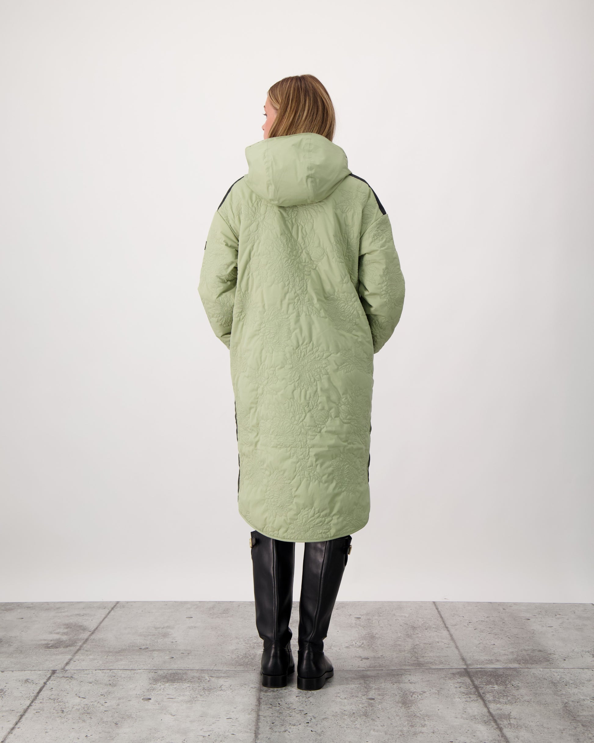 Surrey Women's Performance Quilted Long Mid Layer Jacket in knee length, Primaloft Gold Insulation Active+, non-removable hood, single welt magnetic closure pockets, ribbed cuffs, two-way centre front zipper, grosgrain ribbon detail and shoulders and side seam, and snap closure side seam vents, in Tea