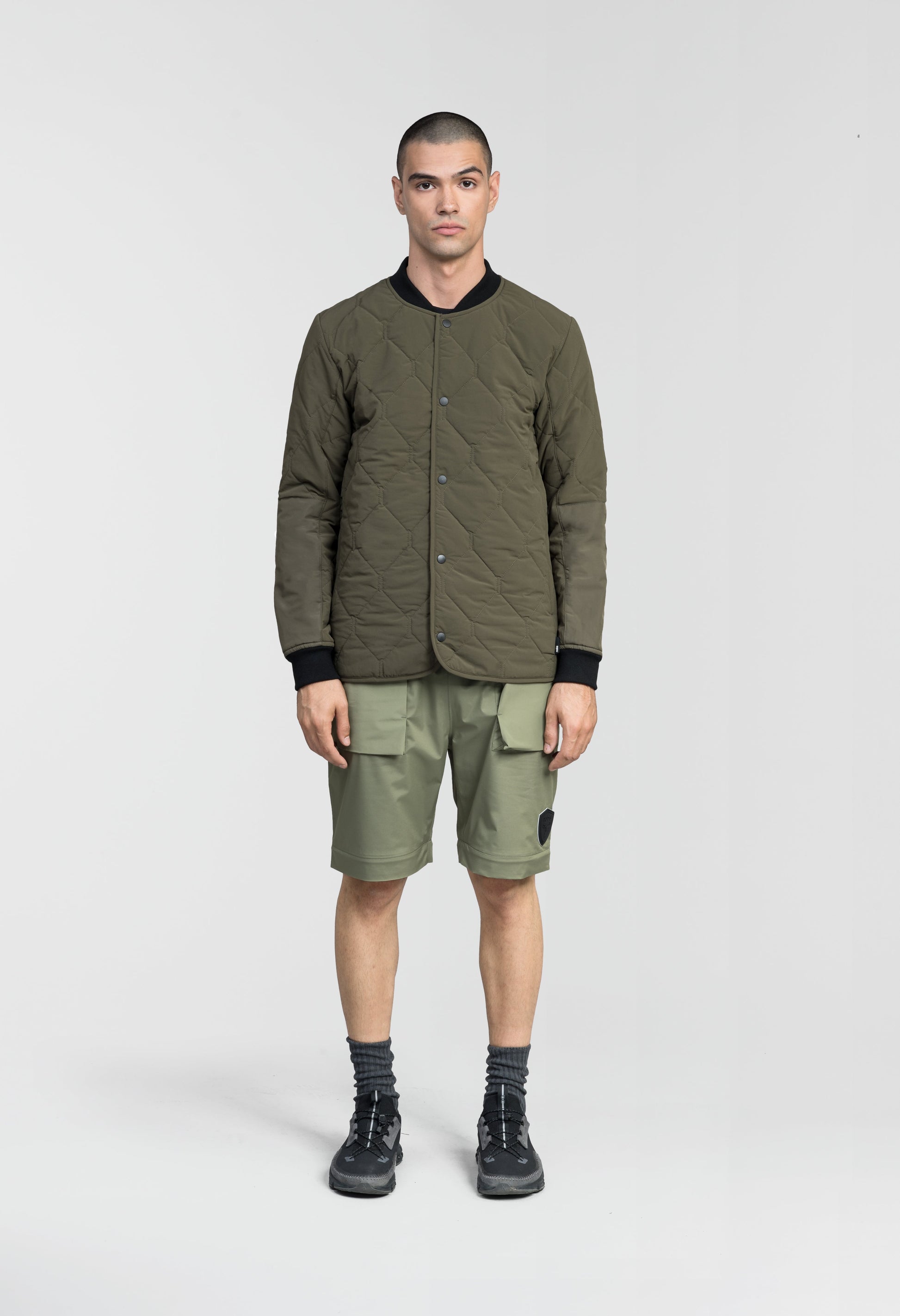 Speck Men's Tailored Mid Layer Jacket in hip length, Primaloft Gold Insulation Active+, diamond quilted body, rib knit collar and cuffs, snap buton front closure, and hidden side-entry zipper pockets at waist, in Fatigue