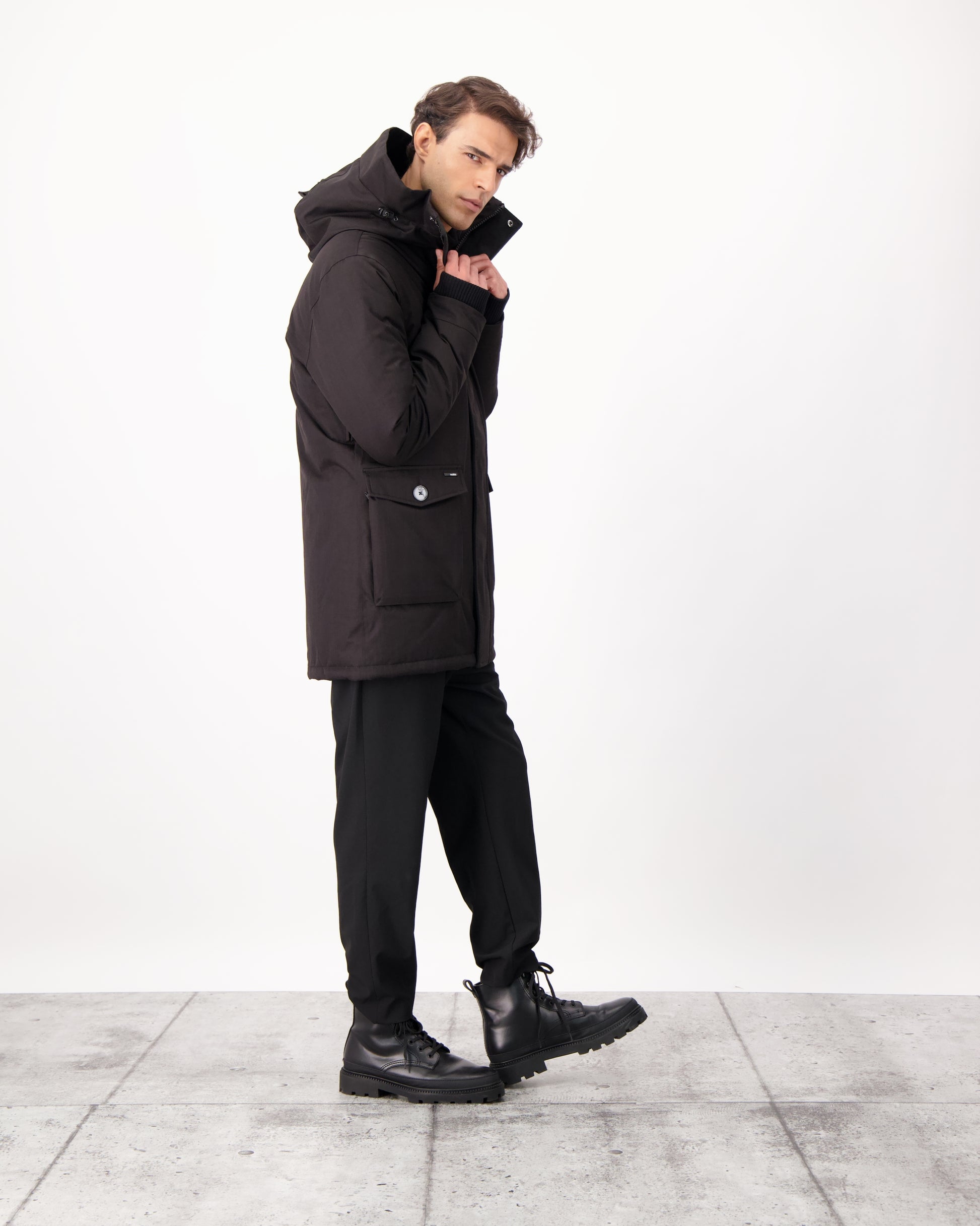 Yves Furless Men's Parka in thigh length, Canadian white duck down insulation, non-removable down-filled hood, flap pockets at waist, centre-front two-way zipper with magnetic wind flap, and elastic ribbed cuffs, in CH Black