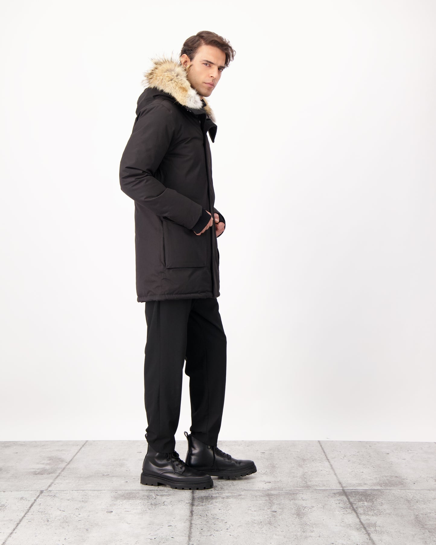 Men's slim fitting waist length parka with removable fur trim on the hood and two waist patch pockets in CH Black