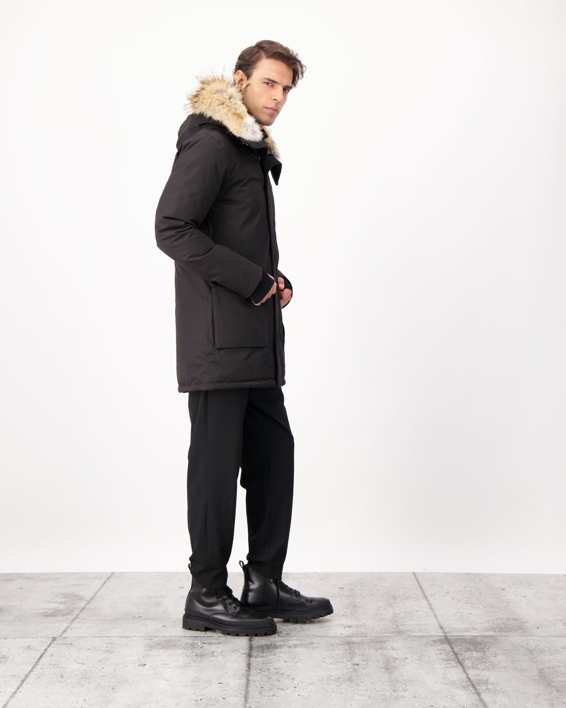 Men's slim fitting waist length parka with removable fur trim on the hood and two waist patch pockets in CH Black