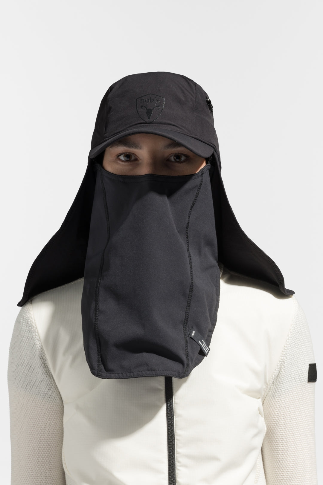 Tal Unisex 3-in-1 cap in 5-panel construction, curved peak brim, back flap, adjustable cobra buckle at back, zipper pocket on left side crown, and detachable face covering, in Black