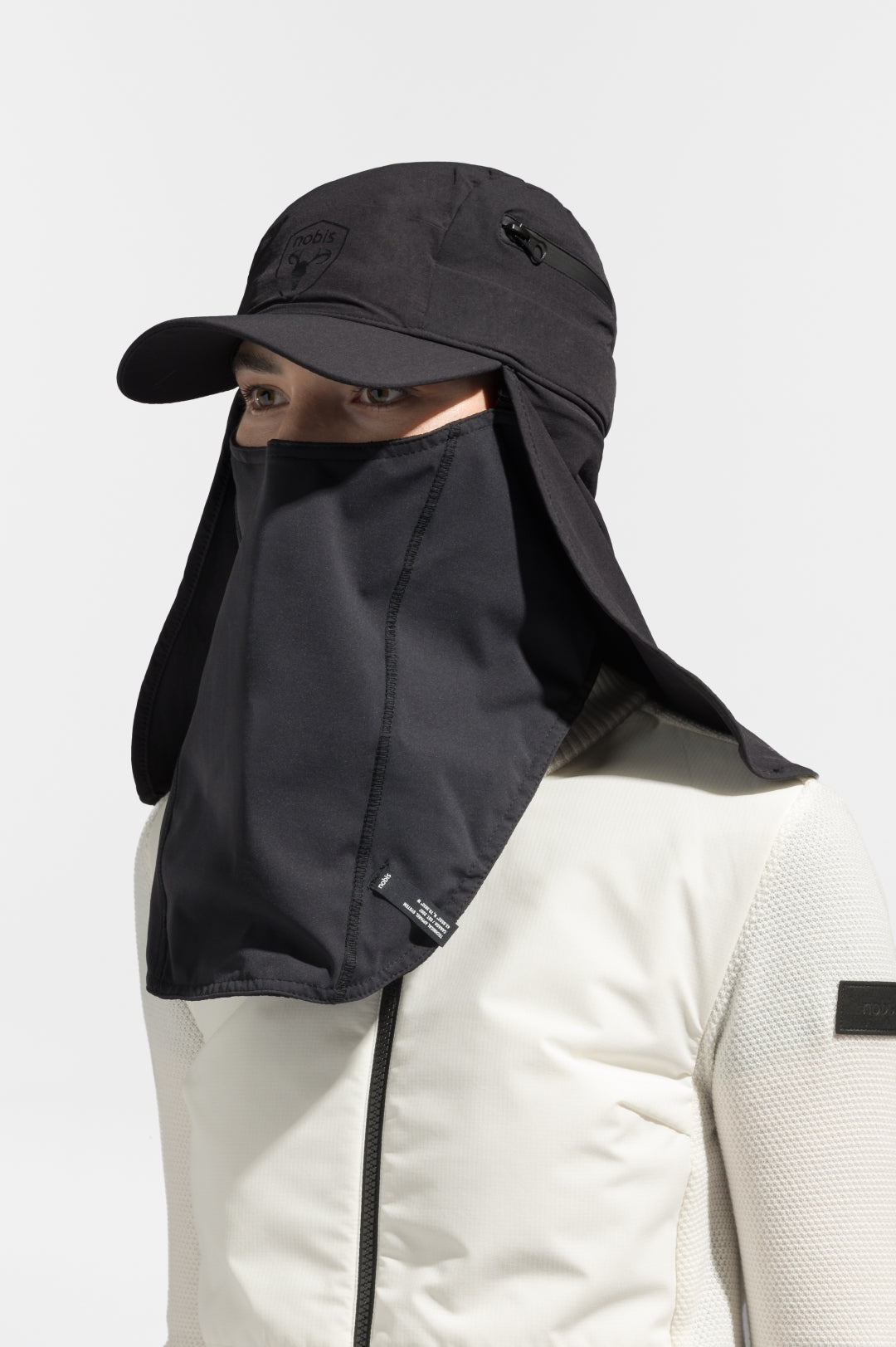 Tal Unisex 3-in-1 cap in 5-panel construction, curved peak brim, back flap, adjustable cobra buckle at back, zipper pocket on left side crown, and detachable face covering, in Black