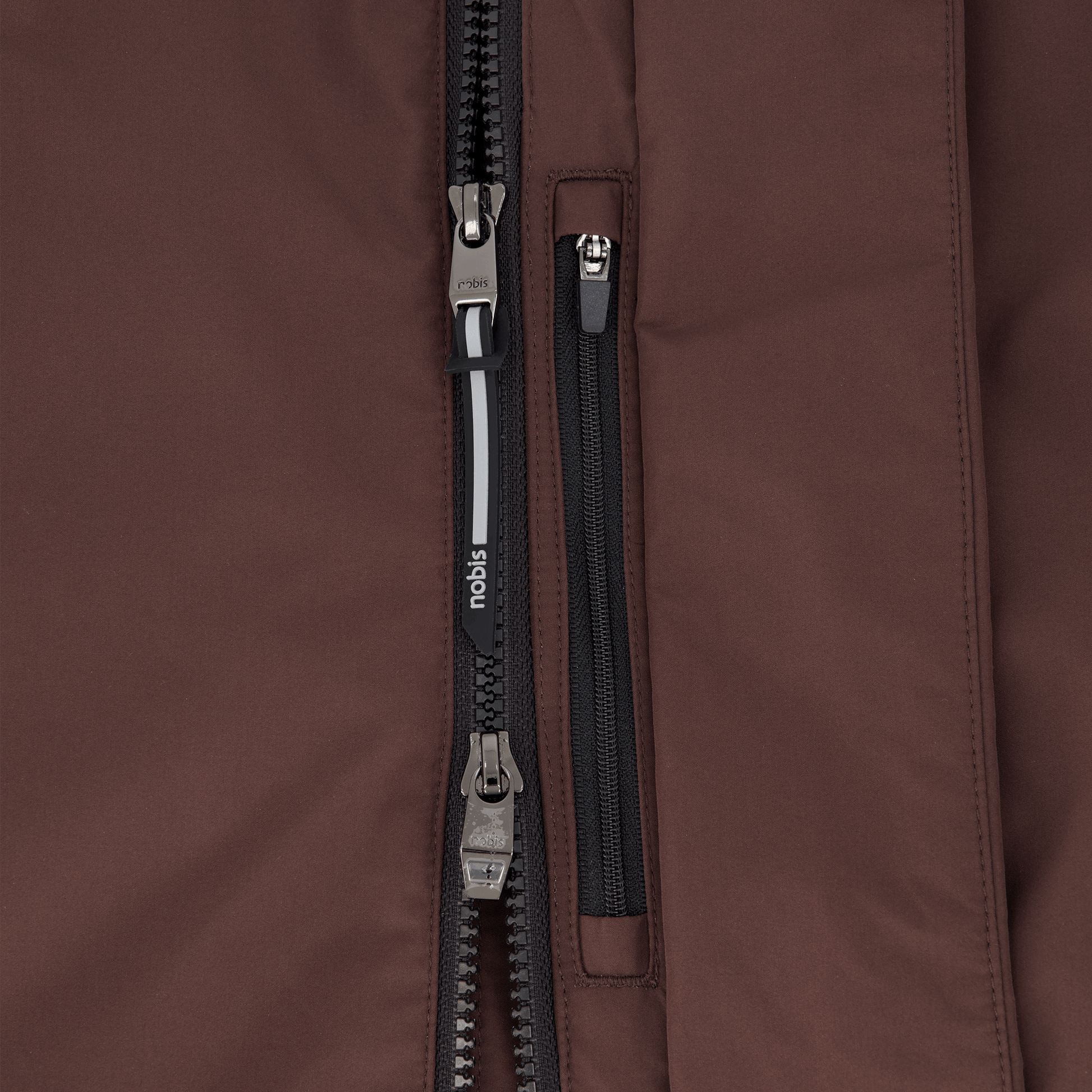 Upton long jacket in Coffee Bean in 3-ply Micro Denier fabric with DWR coating, featuring a two-way zipper with magnetic closure, hidden mesh ventilation, and underarm vents. Designed for weather protection and tailored comfort.