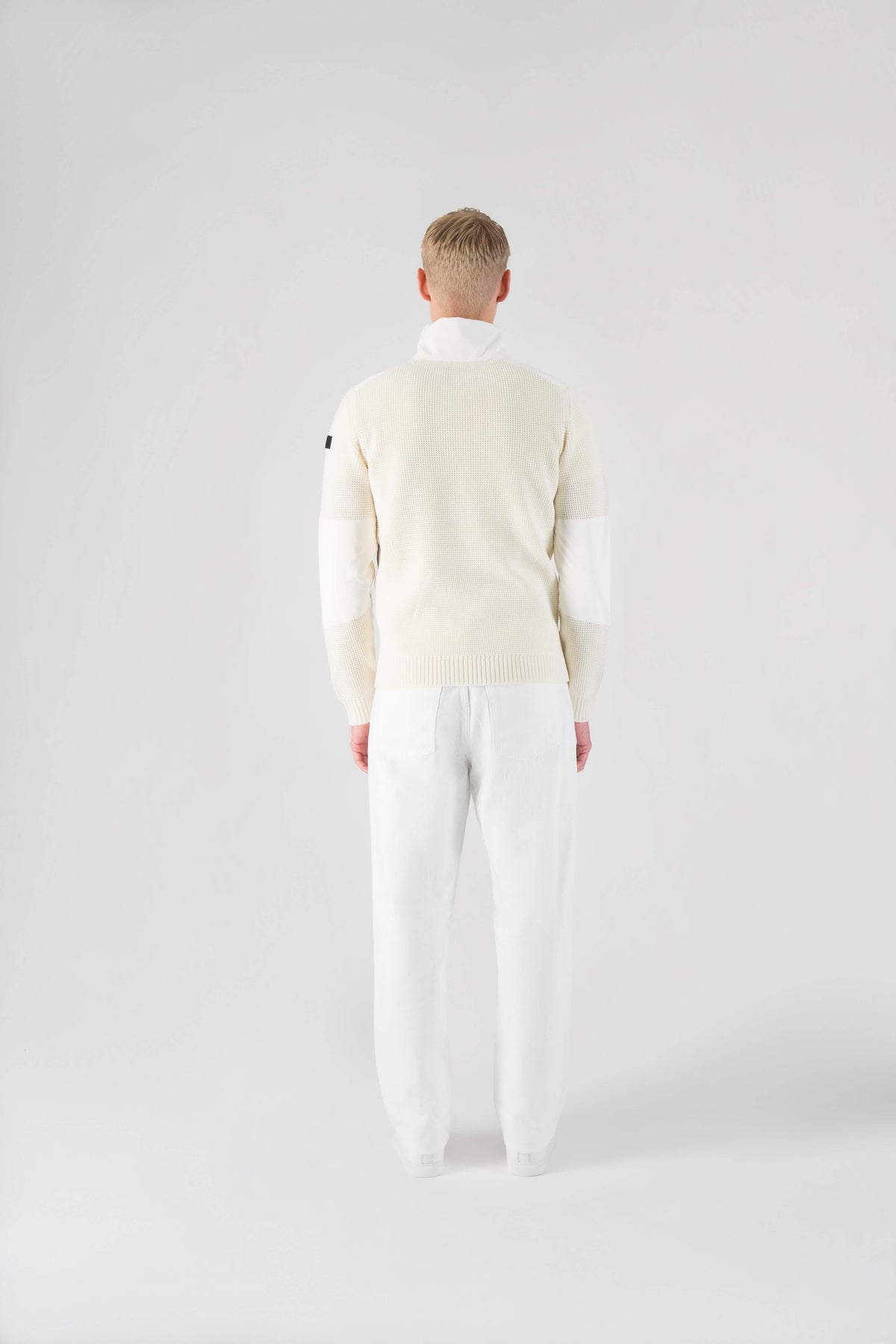Wai Men's Performance Half Zip Sweater in hip length, 3-Ply Micro Denier and Merino wool knit fabrication, Primaloft Gold Insulation Active+, centre front zipper, flap kangaroo pocket with magnetic closure, and hidden side-entry zipper pockets at waist, in Chalk
