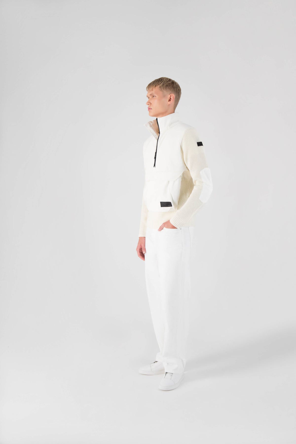 Wai Men's Performance Half Zip Sweater in hip length, 3-Ply Micro Denier and Merino wool knit fabrication, Primaloft Gold Insulation Active+, centre front zipper, flap kangaroo pocket with magnetic closure, and hidden side-entry zipper pockets at waist, in Chalk