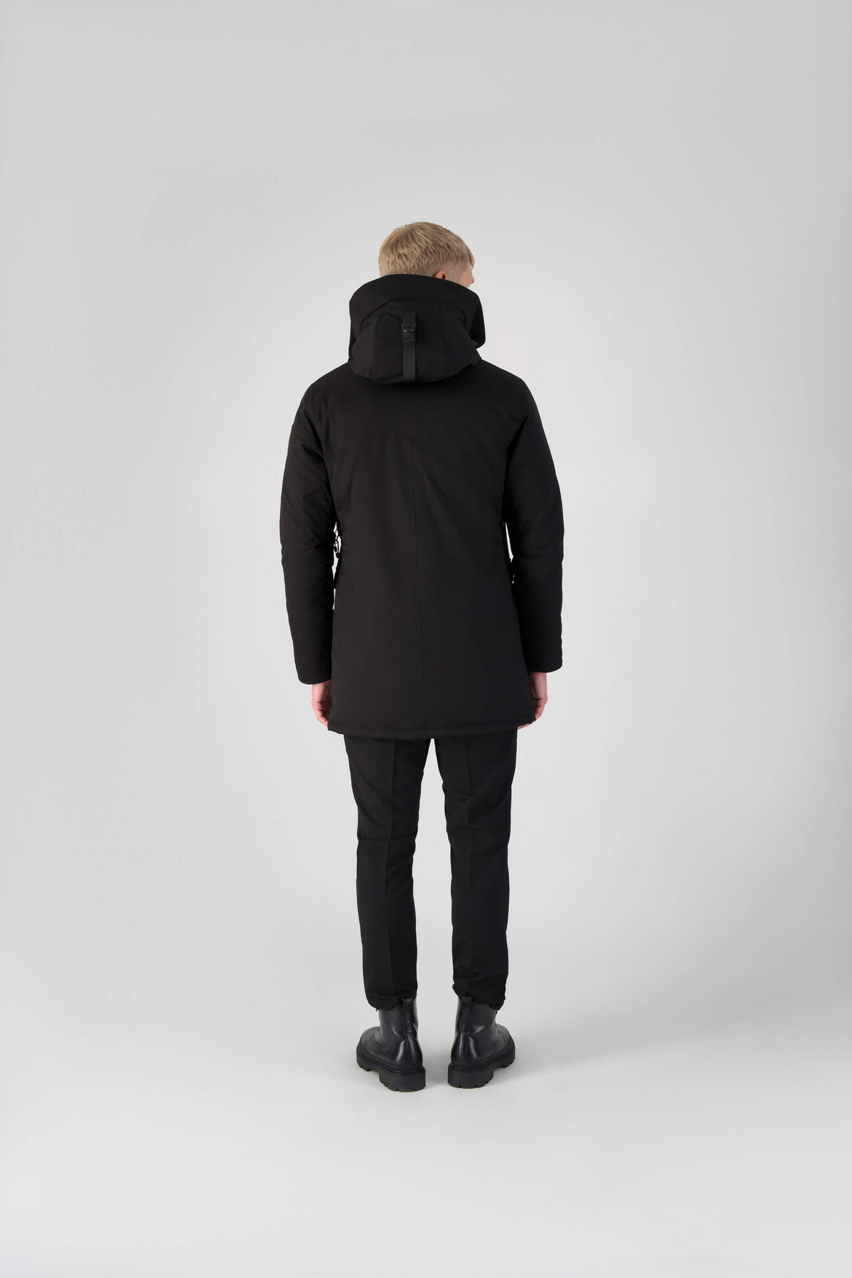 Men's slim fitting waist length parka with removable fur trim on the hood and two waist patch pockets in Black