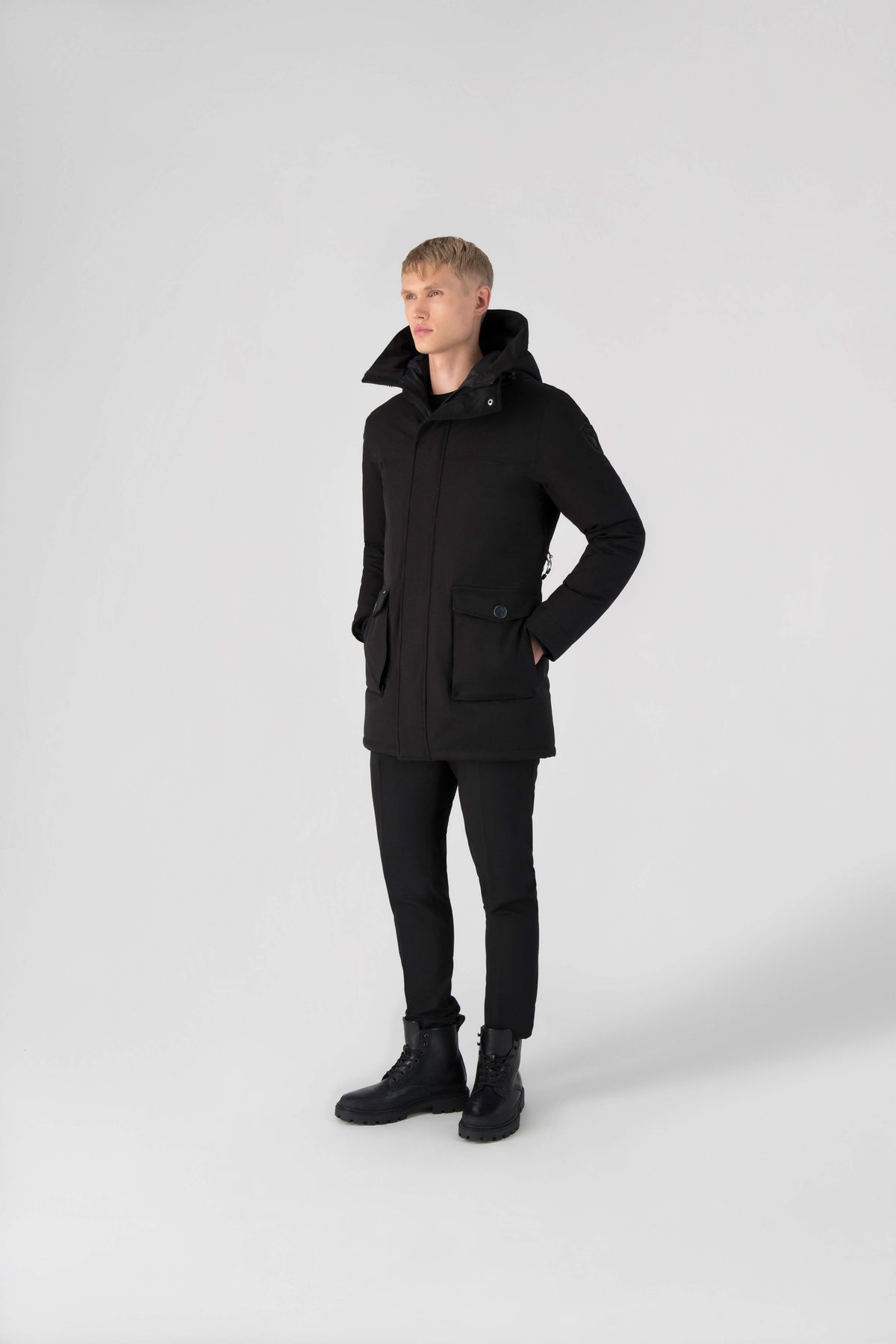 Men's slim fitting waist length parka with removable fur trim on the hood and two waist patch pockets in Black