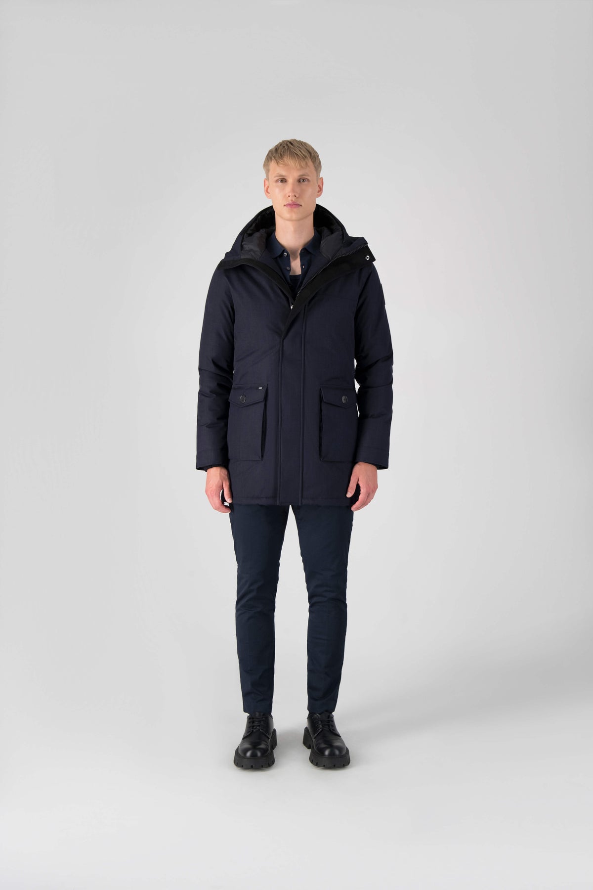 Men's slim fitting waist length parka with removable fur trim on the hood and two waist patch pockets in Navy