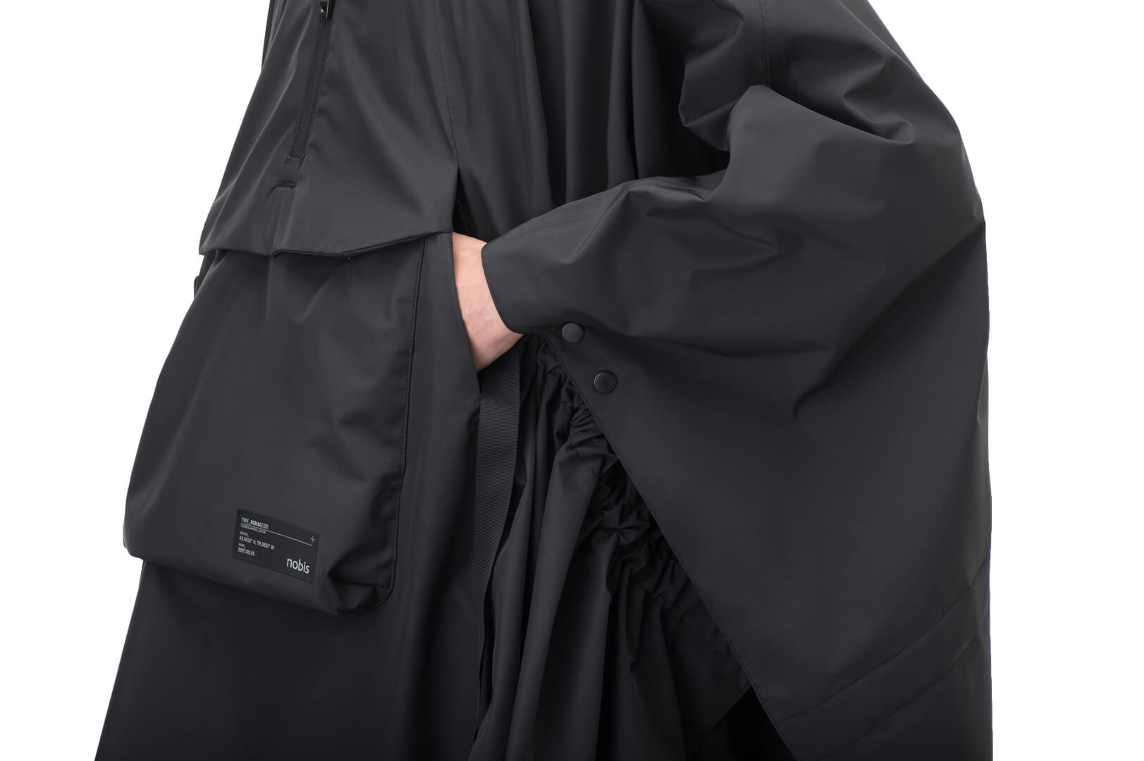 Hydra Unisex Performance Poncho in thigh length, non-removable hood, vertical half-zipper along centre front collar, hidden side-entry waist zipper pockets, adjustable webbing straps and snap closure cuffs, and packable to front kangaroo pocket with flap opening, in Black