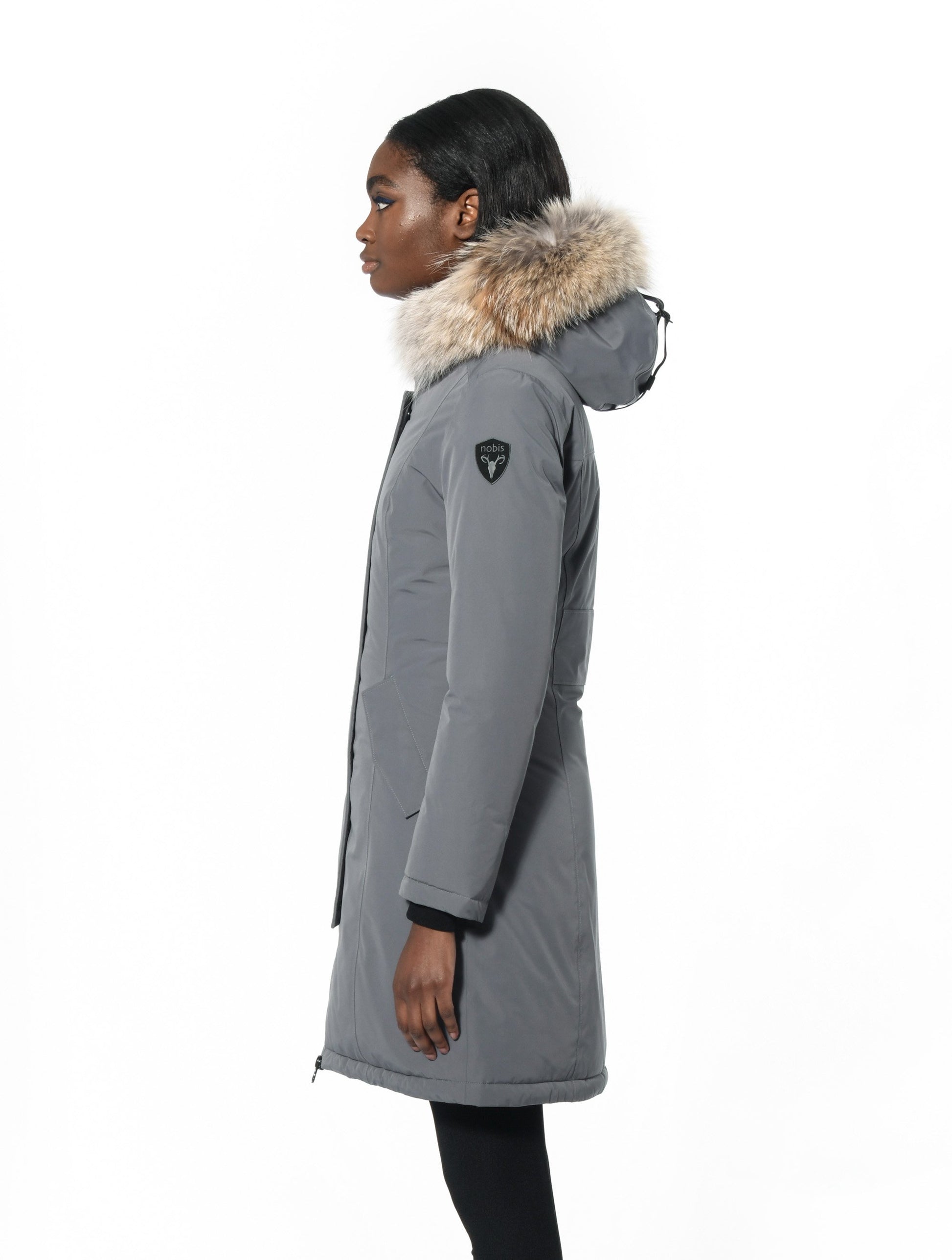Ladies thigh length down-filled parka with non-removable hood and removable coyote fur trim in Concrete