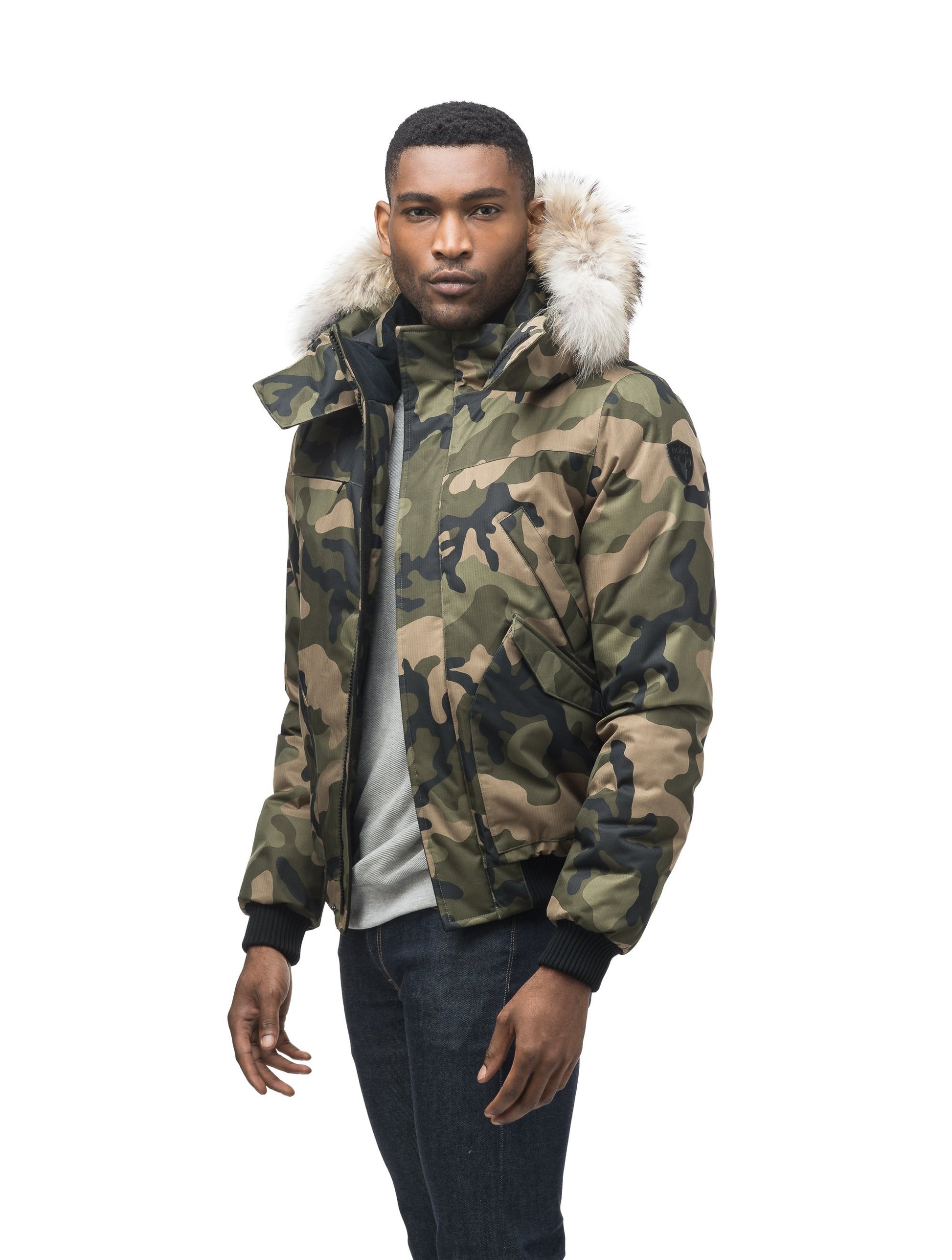 Men's classic down filled bomber jacket with a down filledÃ‚Â hood that features a removable coyote fur trim and concealed moldable framing wire in Camo