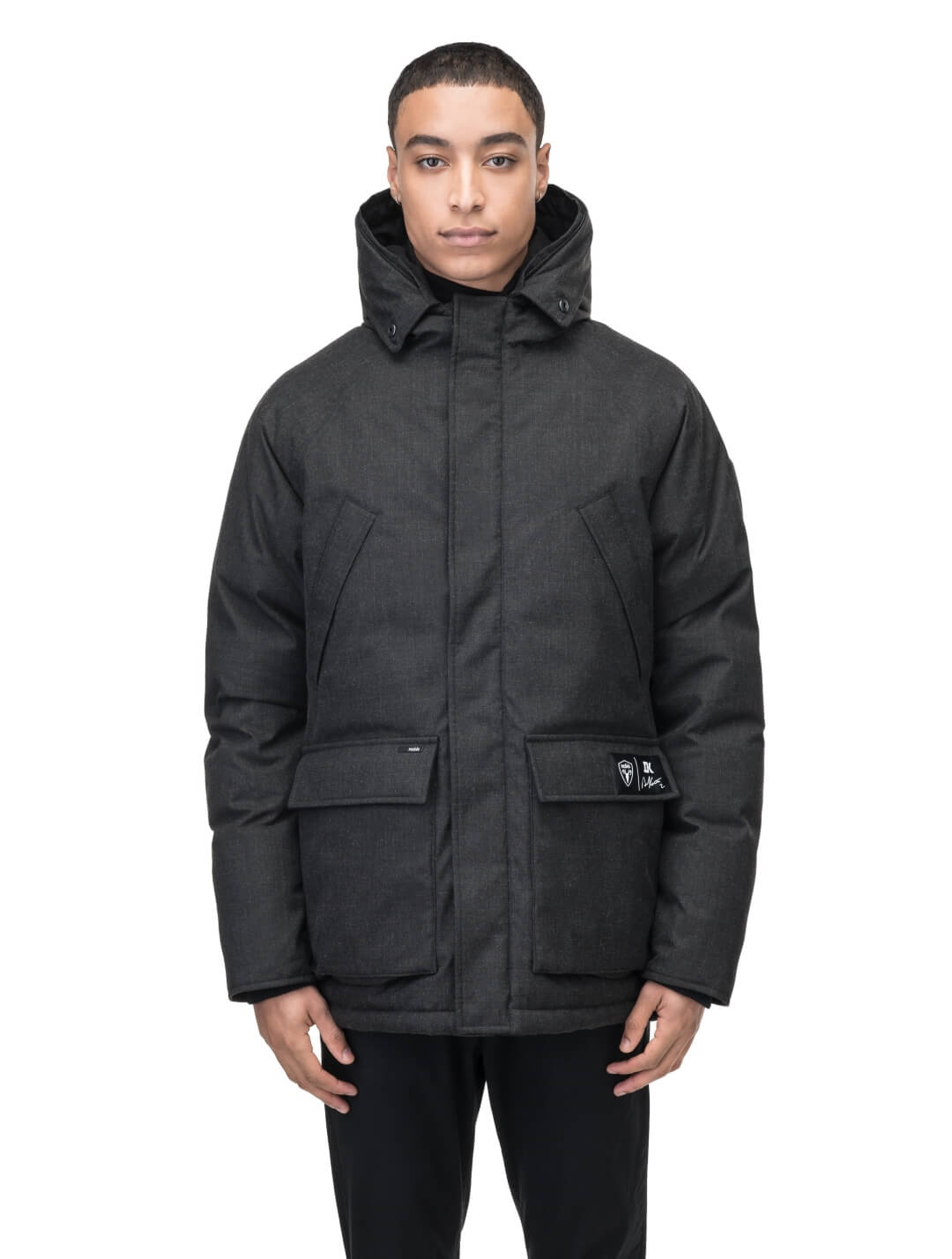 Duncan Keith Heritage Men's Parka in hip length, and features Canadian duck down insulation, non-removable hood with removable coyote fur trim, fleece-lined chest pockets, top and side entry waist pockets, adjustable waist cord, interior zipper pocket, and co-branding with Keith's signature on the left outer waist pocket, in H. Black
