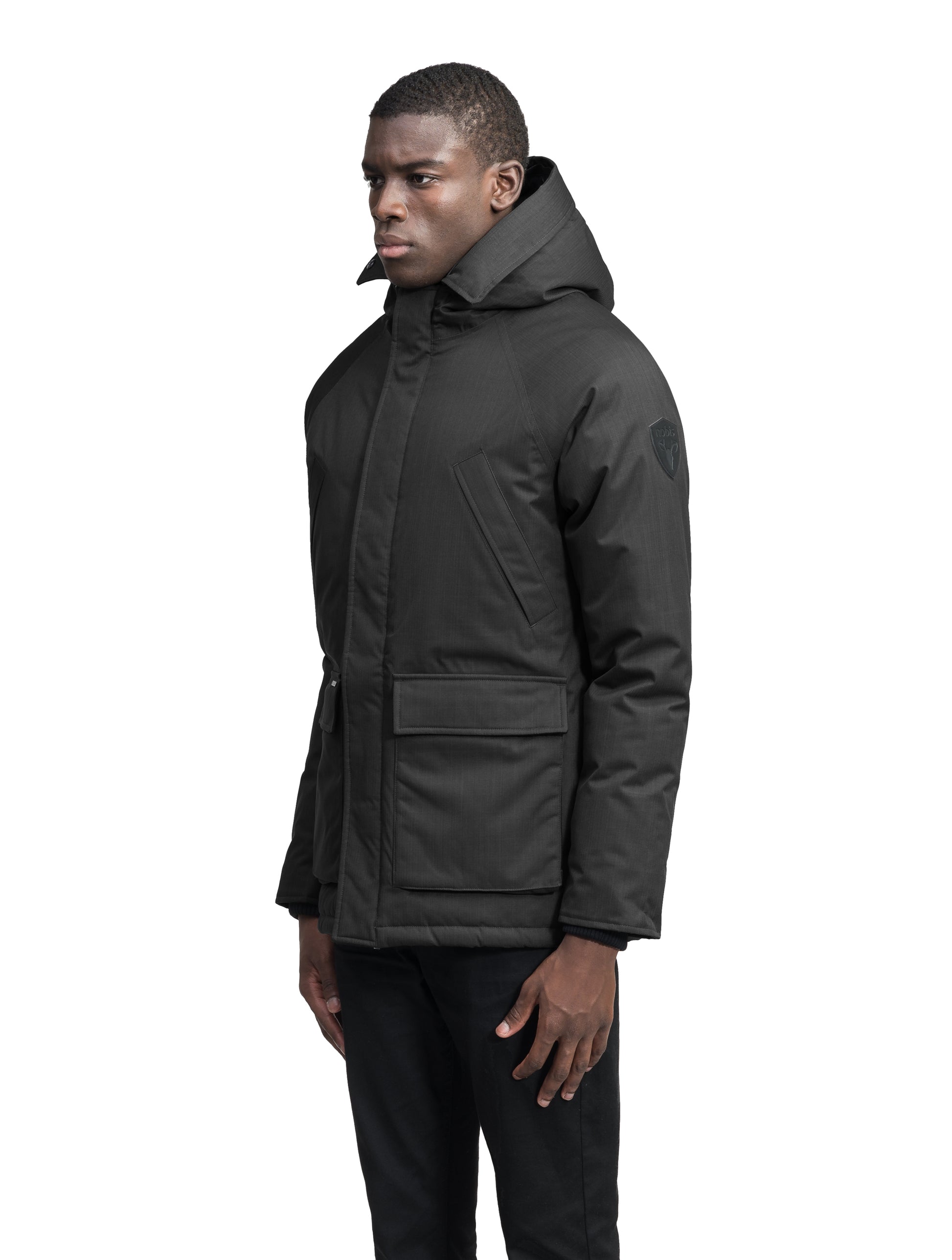 Heritage Furless Men's Parka in hip length, Canadian white duck down insulation, non-removable hood, front zipper with magnetic placket, chest hand warmer pockets, waist flap pockets, and elastic cuffs, in Black