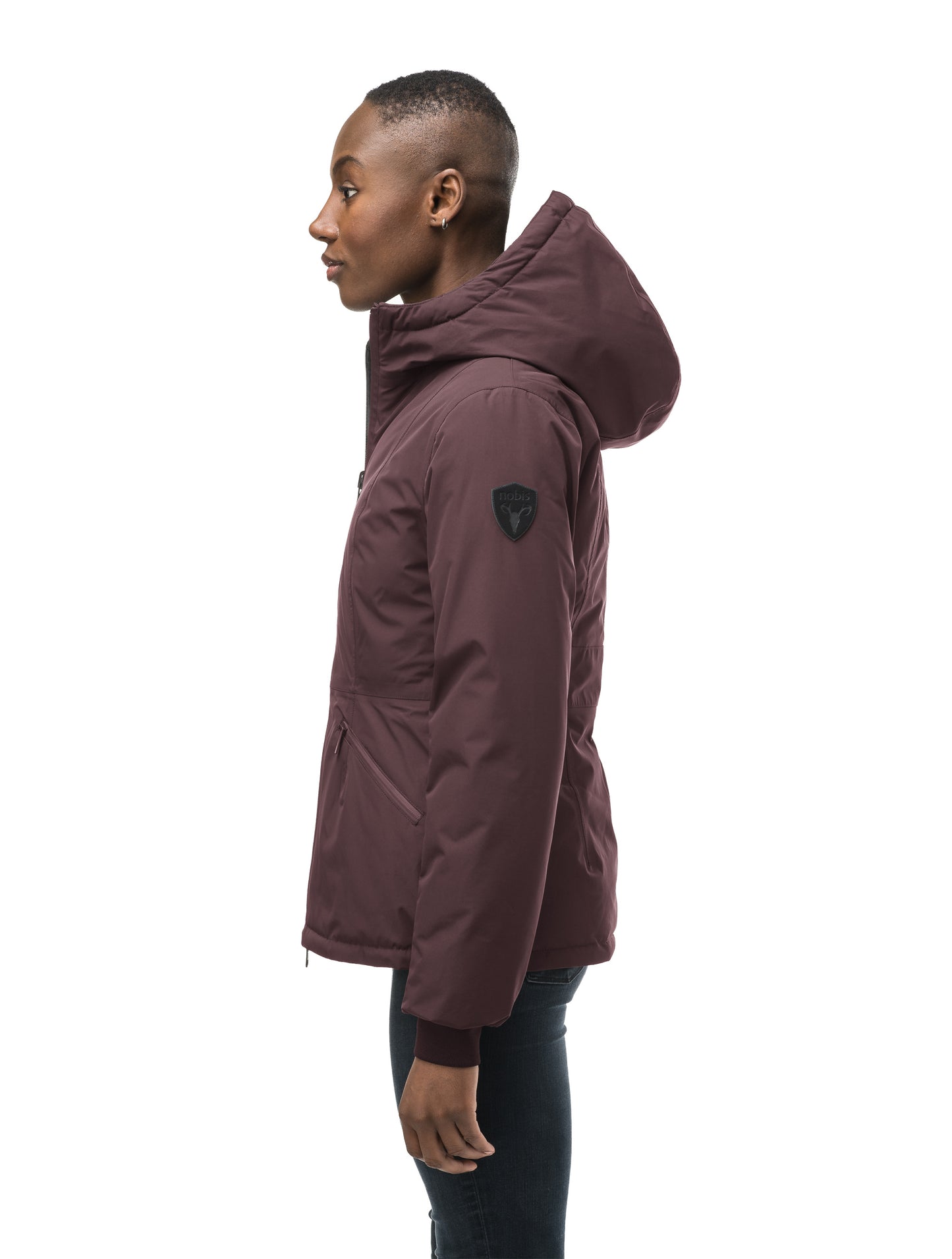 A women's two in one reversible hip length down jacket, one side is quilted and one side is solid waterproof fabric in Burgundy