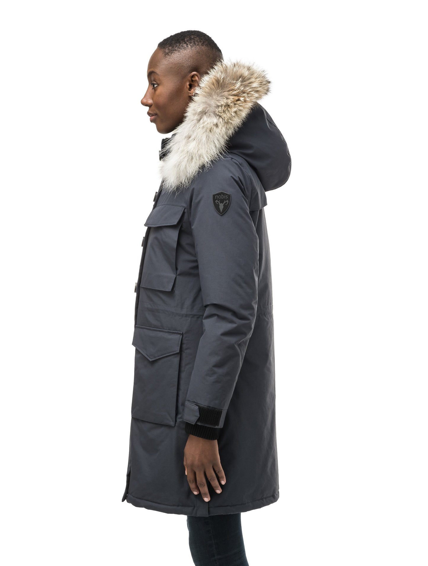 Women's knee length down filled parka with two chest patch pockets and two waist patch pockets in Navy