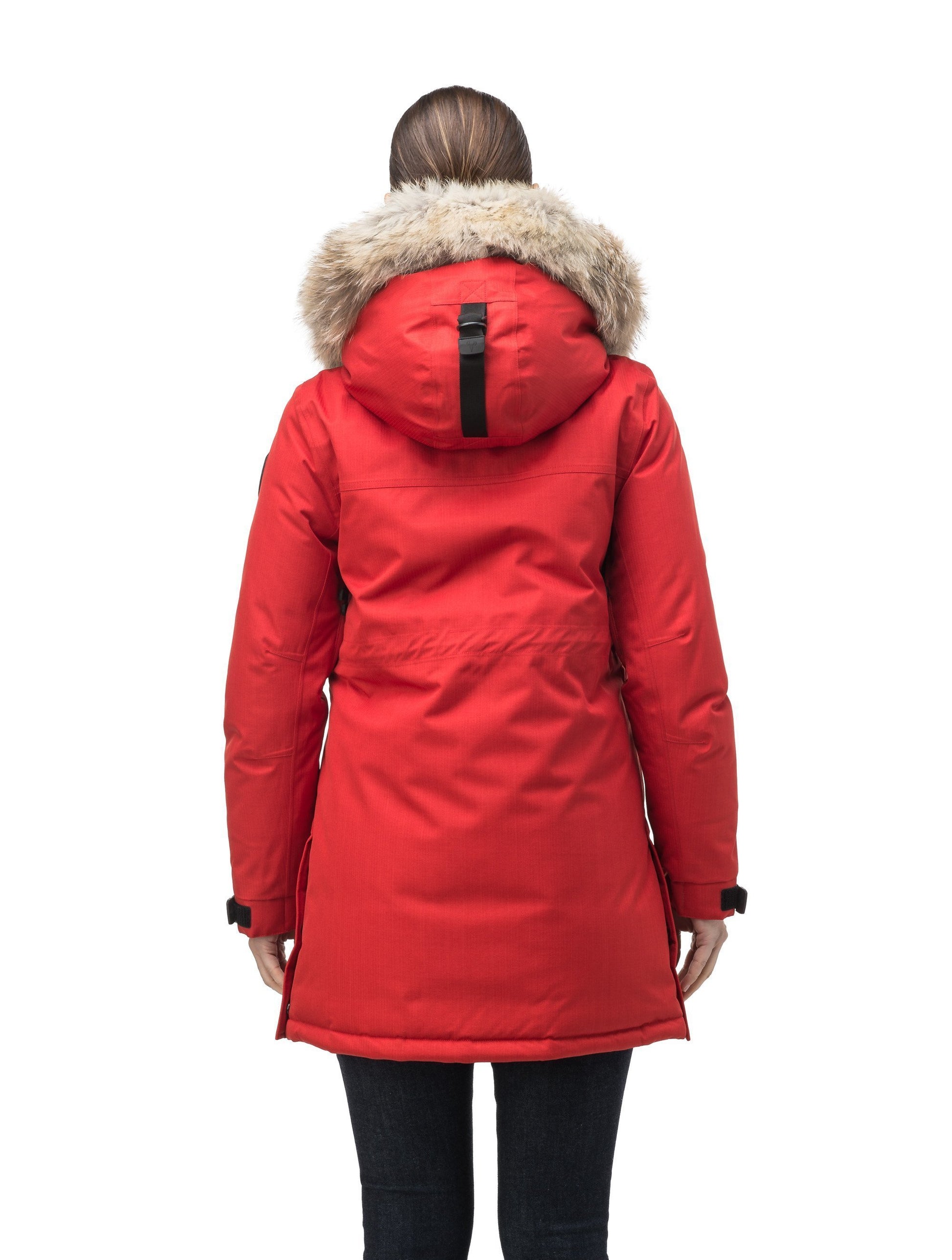 Thigh length women's down filled parka with side entry pockets and drawcord waist, removable hood and fur trim in Vermillion