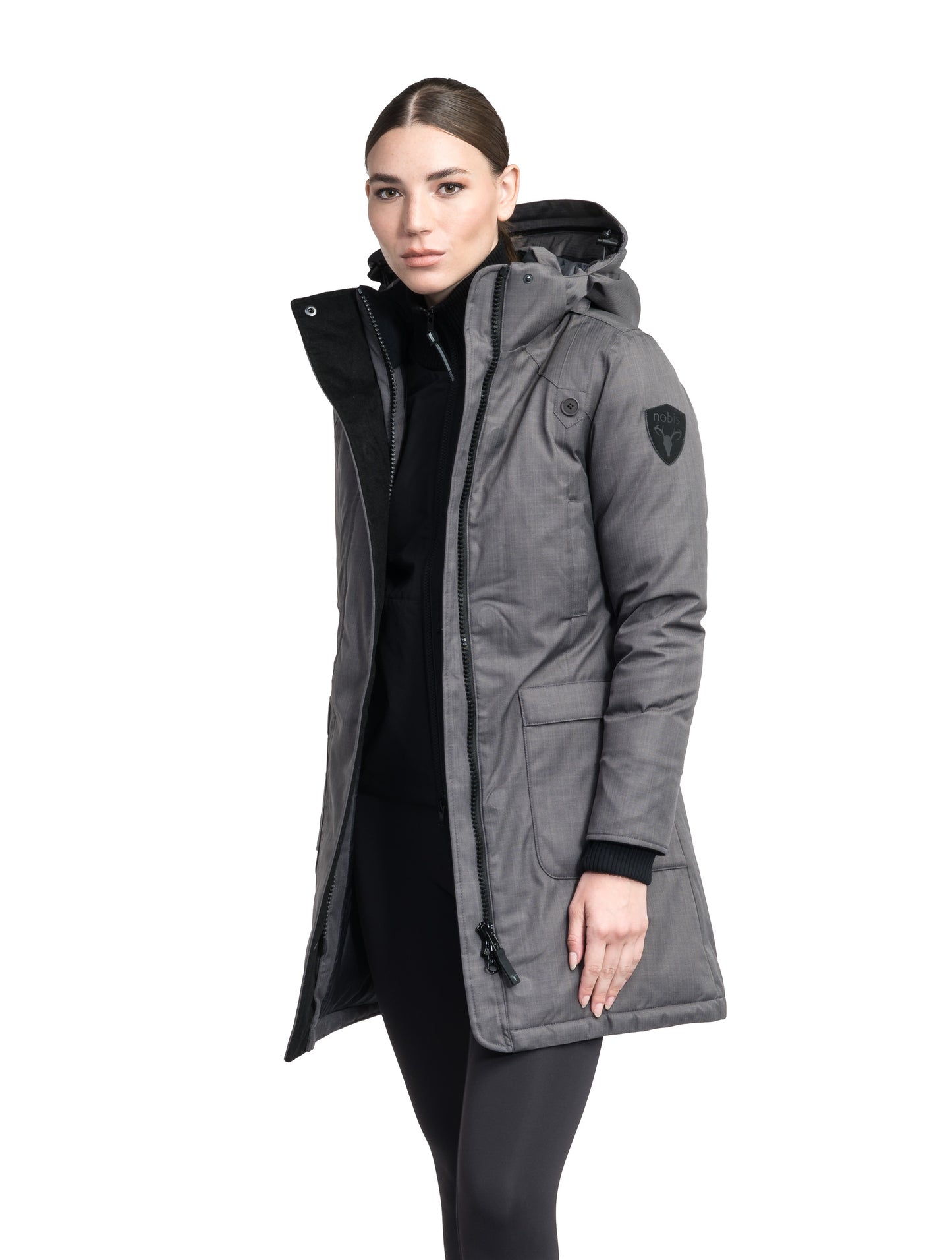 Merideth Furless Ladies Parka in thigh length, Canadian white duck down insulation, removable down-filled hood, centre-front two-way zipper with magnetic wind flap closure, four exterior pockets, and elastic ribbed cuffs, in Steel Grey