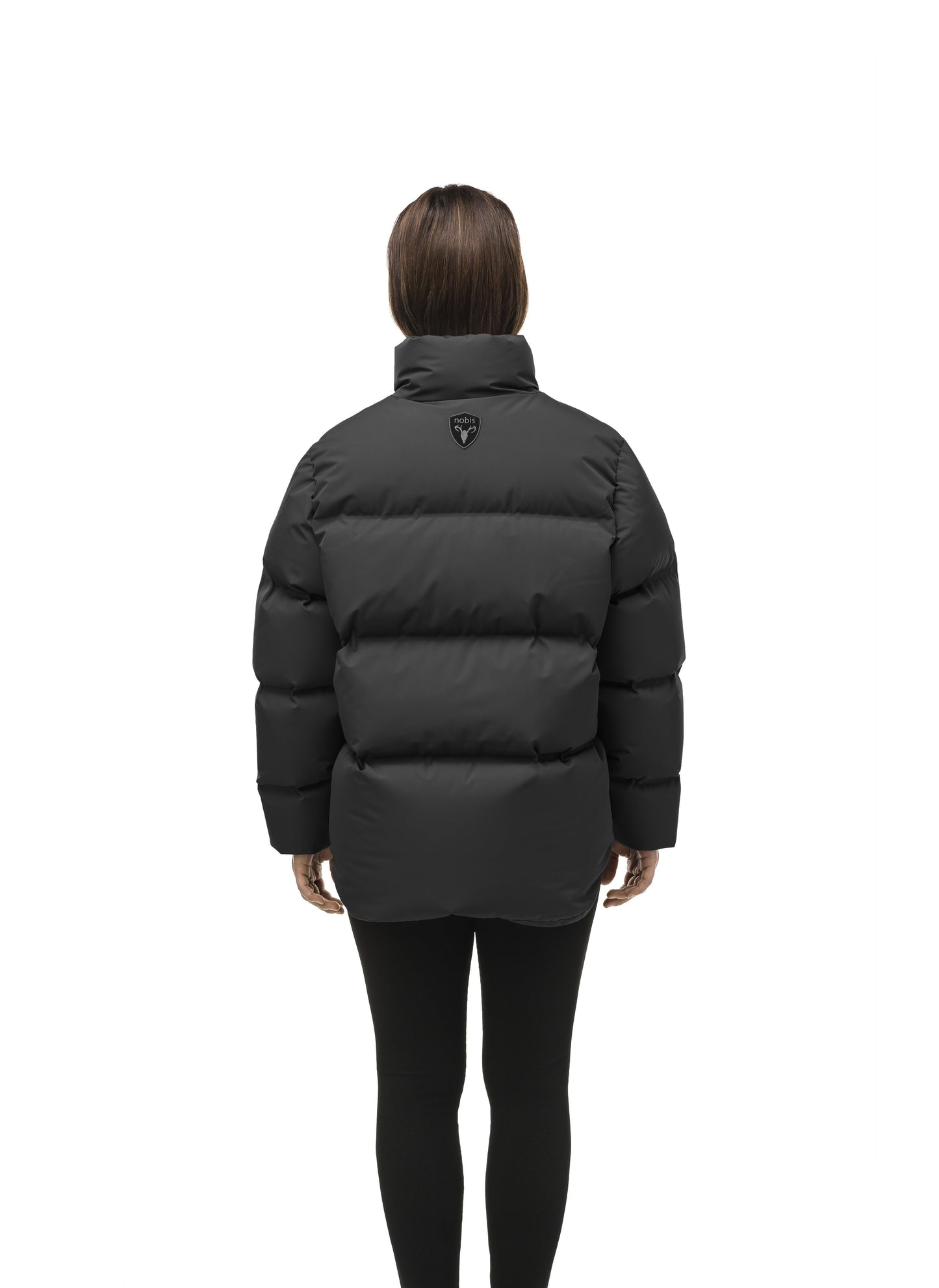 Women's puffer jacket with a minimalist modern design; featuring graphic details like oversized tonal branding, an exposed zipper, and seamless puffer channels to lock in the Premium Canadian Origin White Duck Down in Black