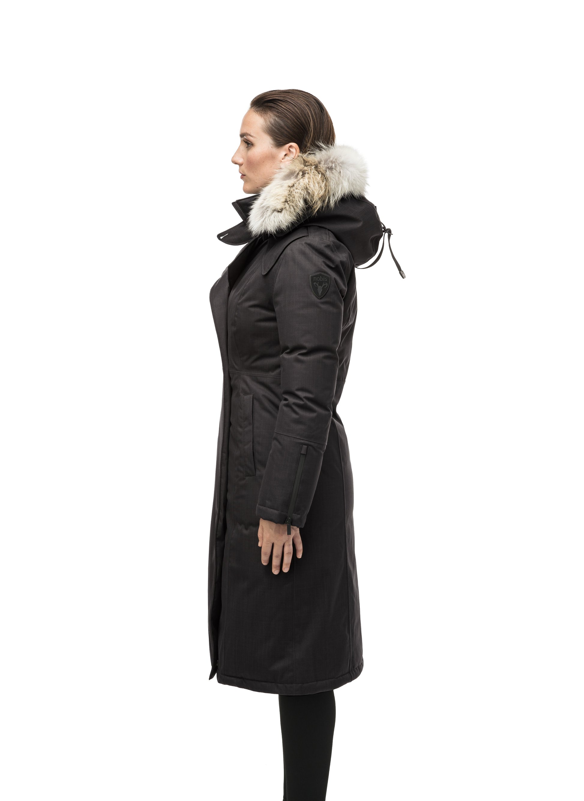 Long calf length women's trench inspired parka with removable fur trim around the hood and an asymetric closure in Black