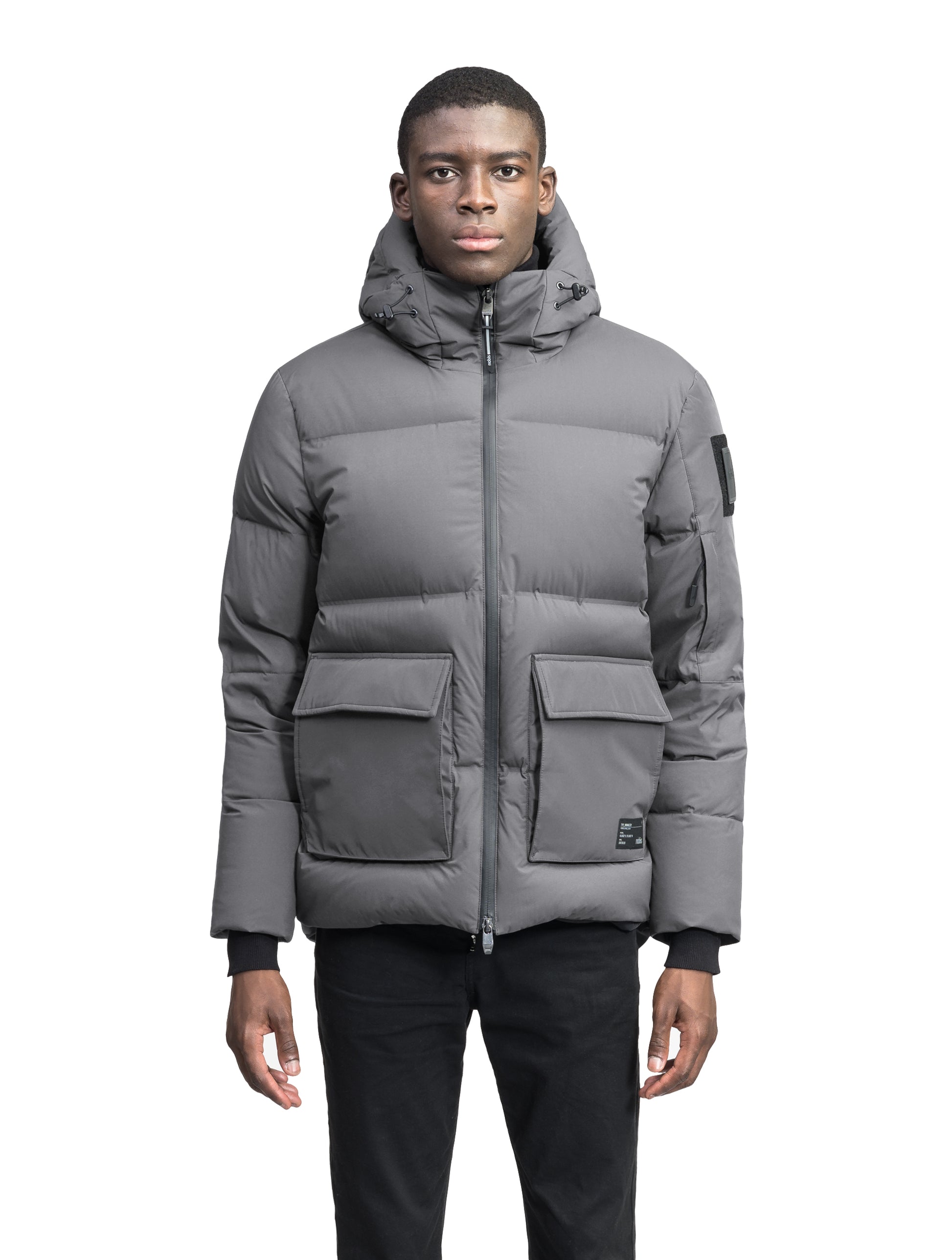 Supra Men's Performance Puffer in hip length, Technical Taffeta and 3-Ply Micro Denier fabrication, Premium Canadian White Duck Down insulation, non-removable down filled hood, centre front two-way zipper, flap pockets at waist, and zipper pocket at left bicep, in Concrete