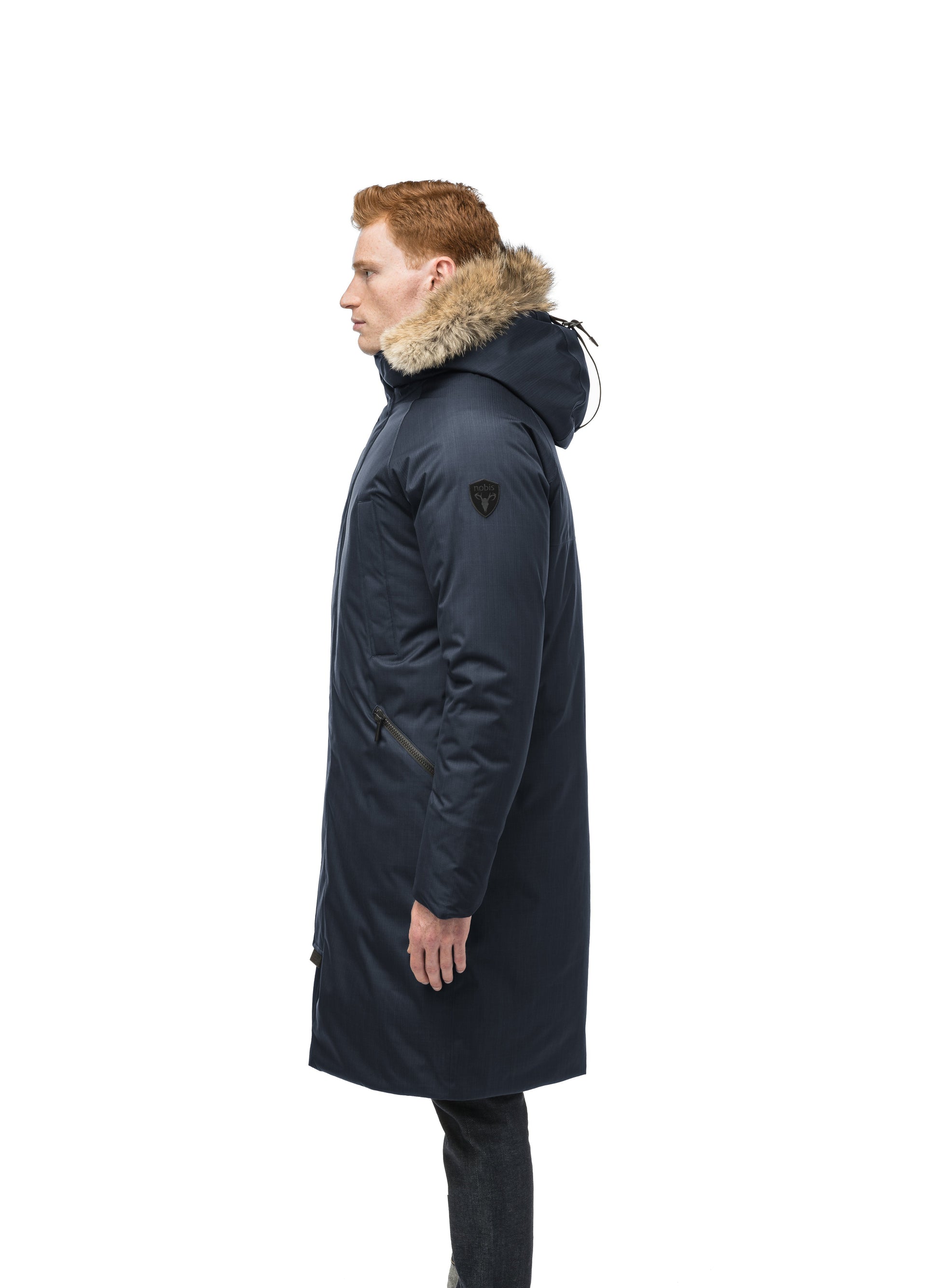 This ankle length men's down filled parka doubles as an over coat with a removable fur trim on the hood in Navy